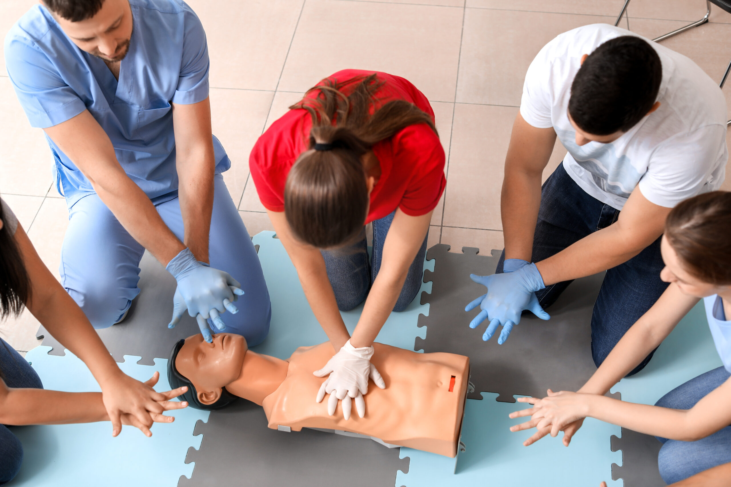 first aid student providing CPR during first aid course